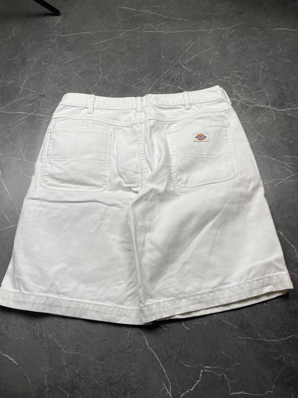 Dickies white cotton work shorts with logo on back pocket and waistband label.