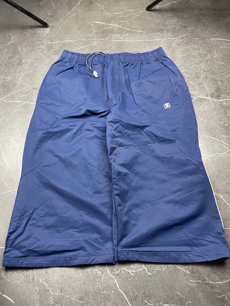 Nike blue woven shorts with elastic waistband, logo on front, and mesh lining.