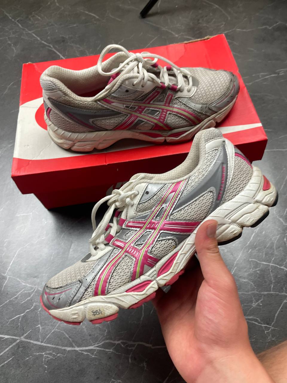 ASICS grey and pink running shoes with breathable mesh panels and rubber soles.