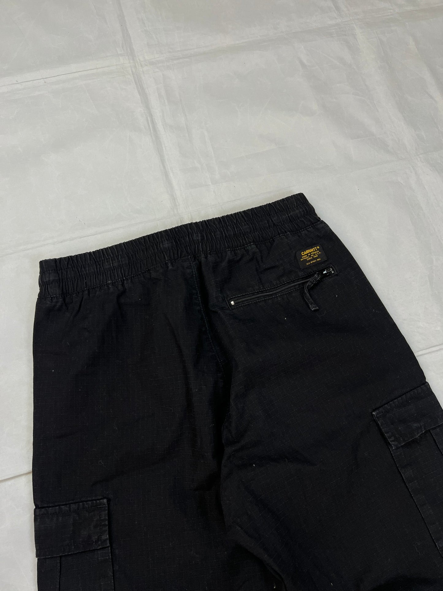 Carhartt black cargo joggers relaxed fit with multiple pockets and elastic cuffs.