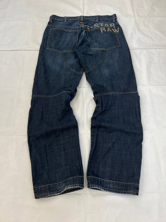 G-Star Raw blue denim jeans with embroidered logo, distinctive seam detailing, and large back pockets.
