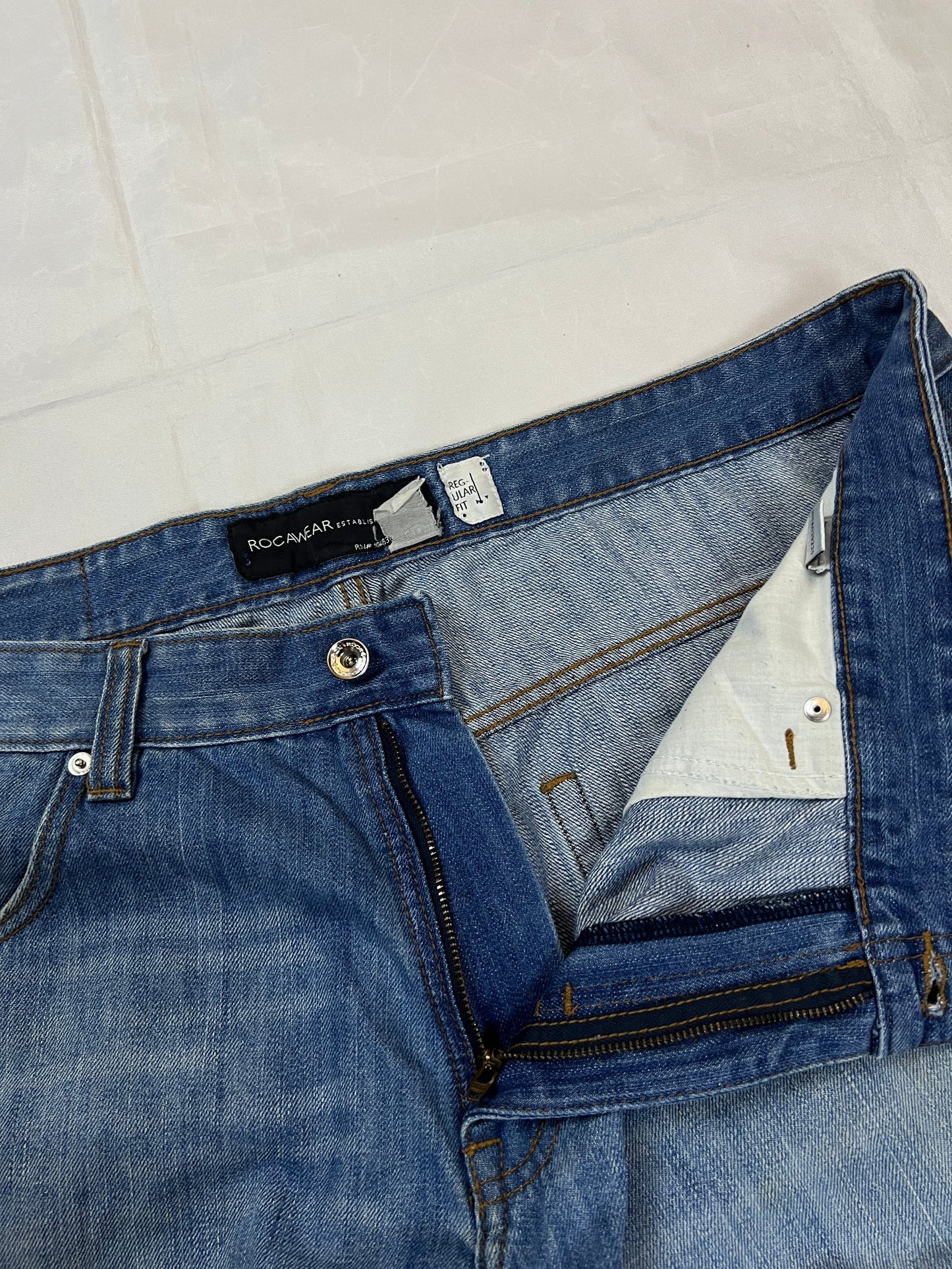 Rocawear blue denim shorts W38 five-pocket design with embroidered back pockets and branded label.