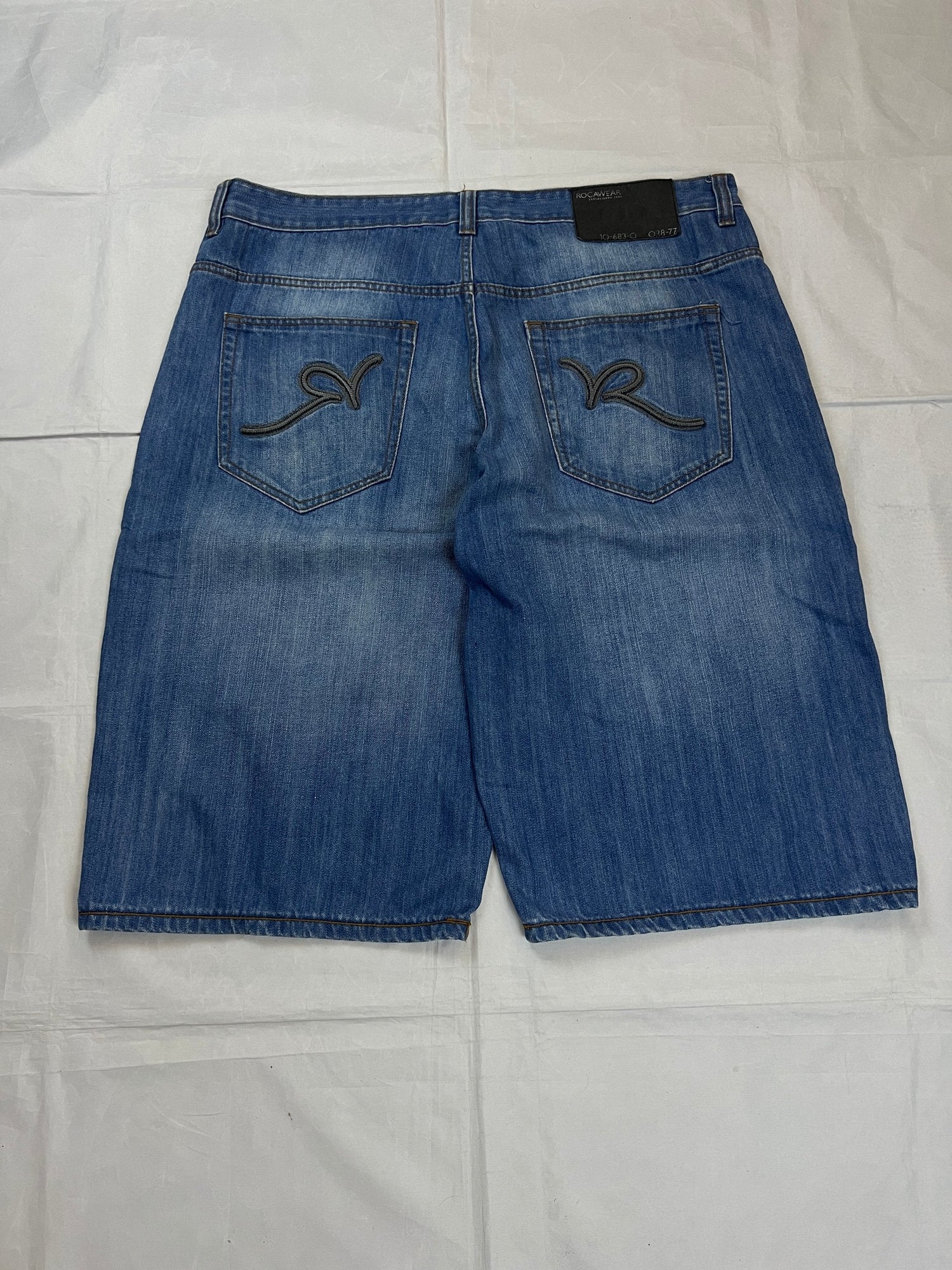 Rocawear blue denim shorts W38 five-pocket design with embroidered back pockets and branded label.