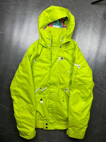 Oakley lime green ski jacket with hood, multicolored interior lining, logo on chest.
