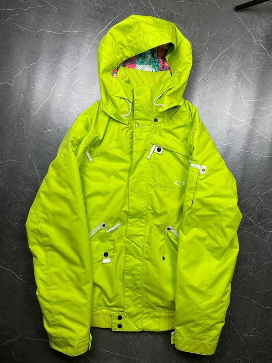 Oakley lime green ski jacket with hood, multicolored interior lining, logo on chest.