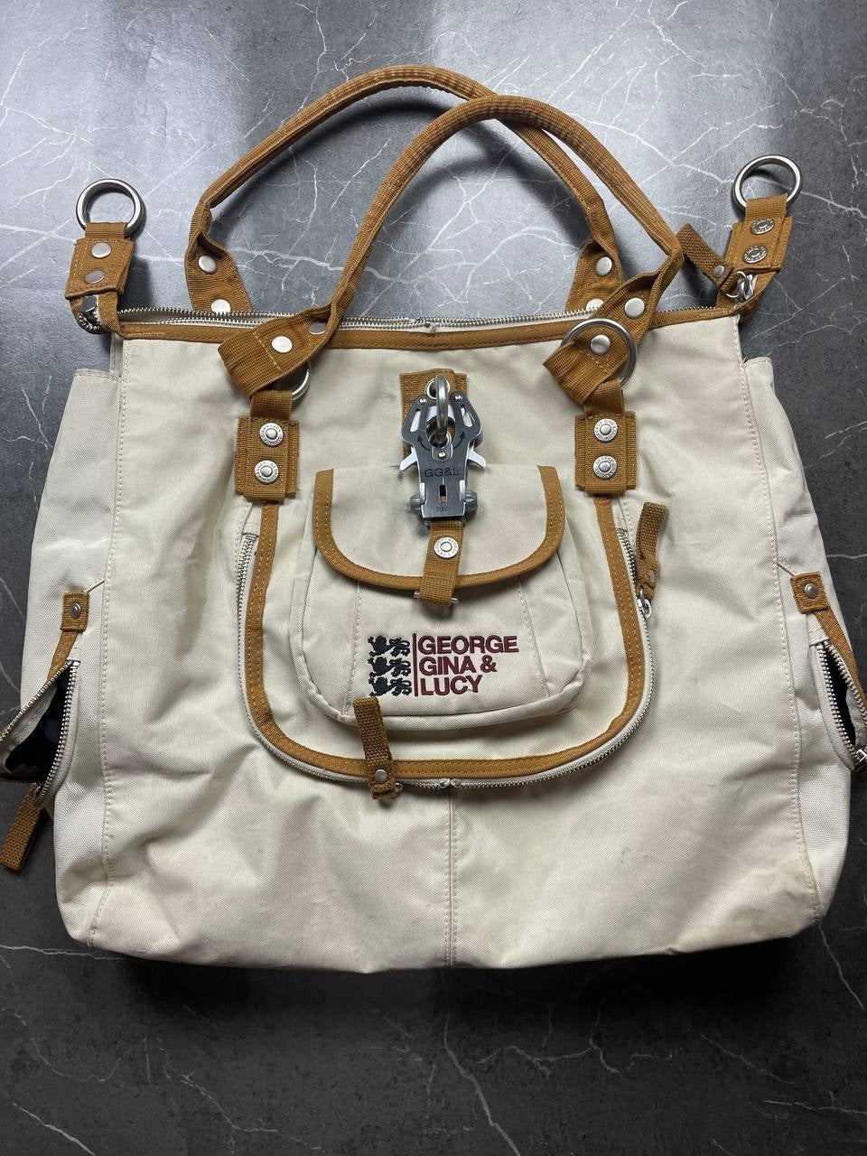 George Gina & Lucy beige canvas shoulder bag with brown straps and embroidered logo.