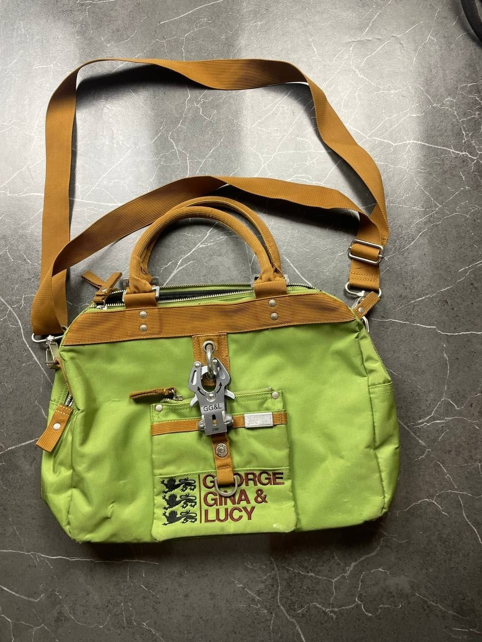 George Gina & Lucy brown and green shoulder bag with embroidered logo and metal clasp.