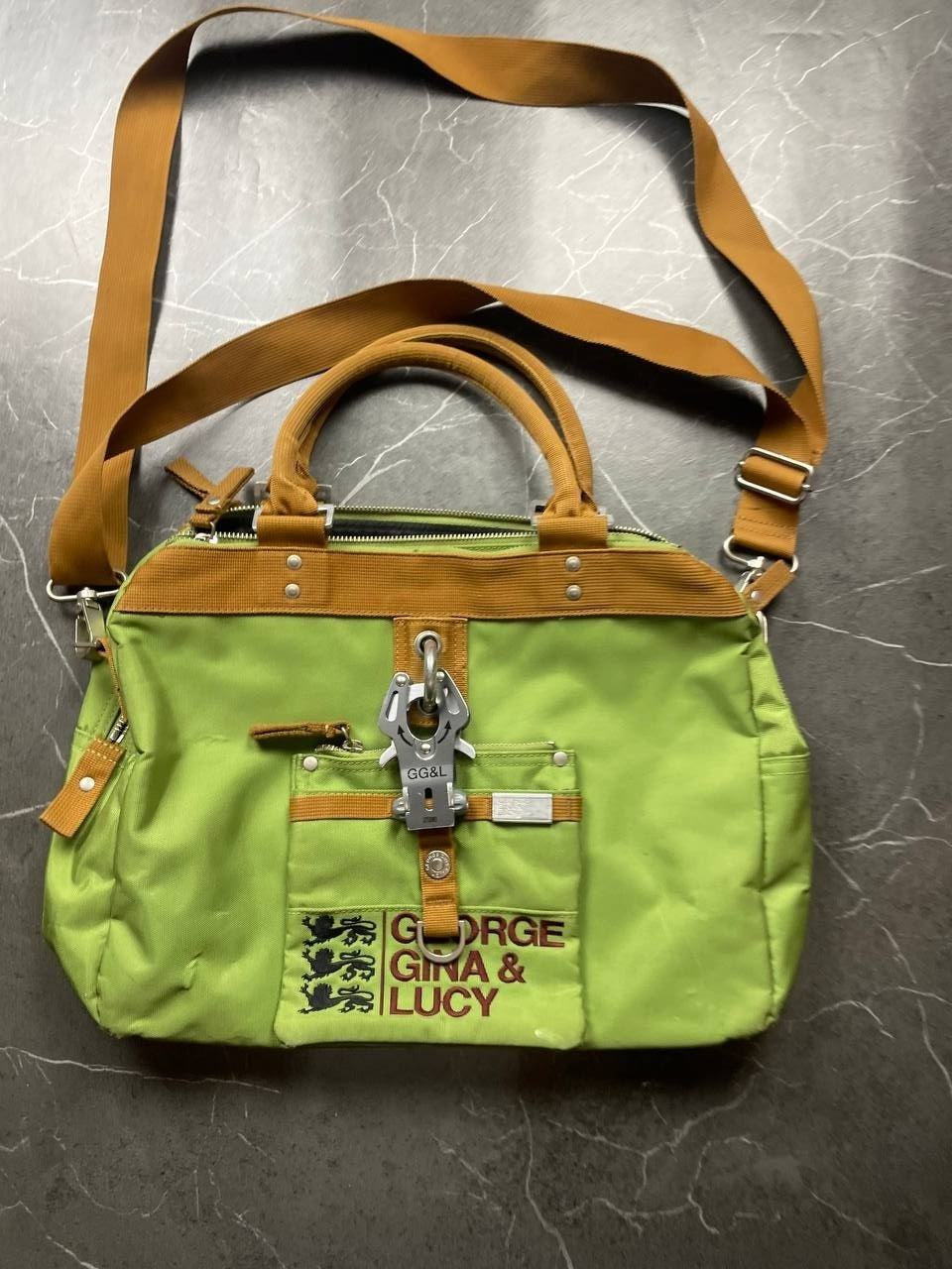 George Gina & Lucy brown and green shoulder bag with embroidered logo and metal clasp.