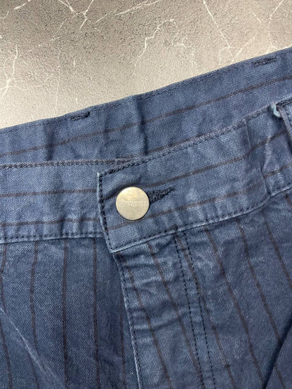 Carhartt navy shorts with pinstripe pattern, utility pockets, and branded metal button.
