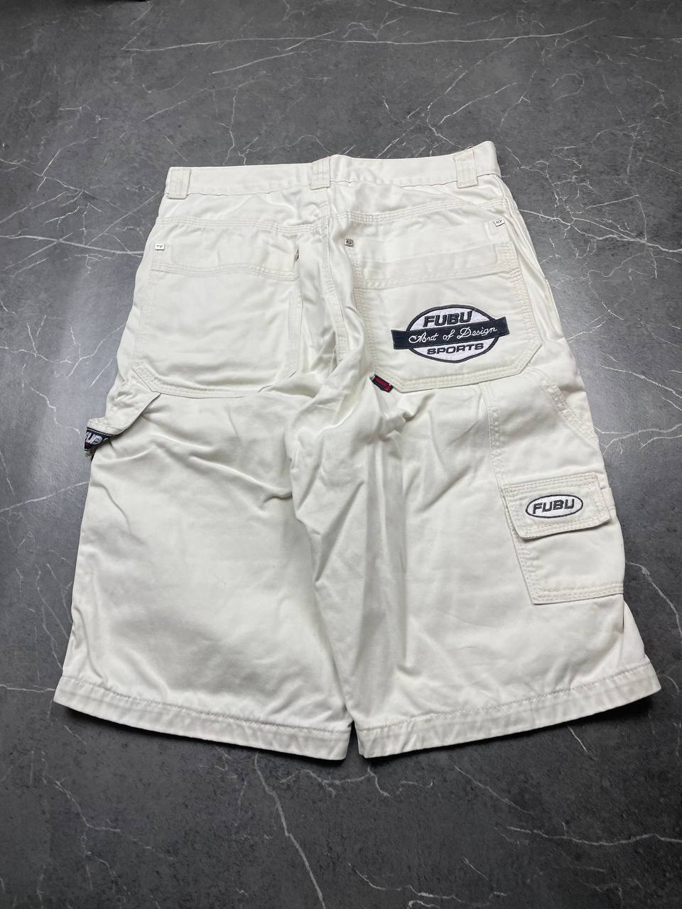 FUBU white cargo shorts 100% cotton with multiple pockets and detailed branding.