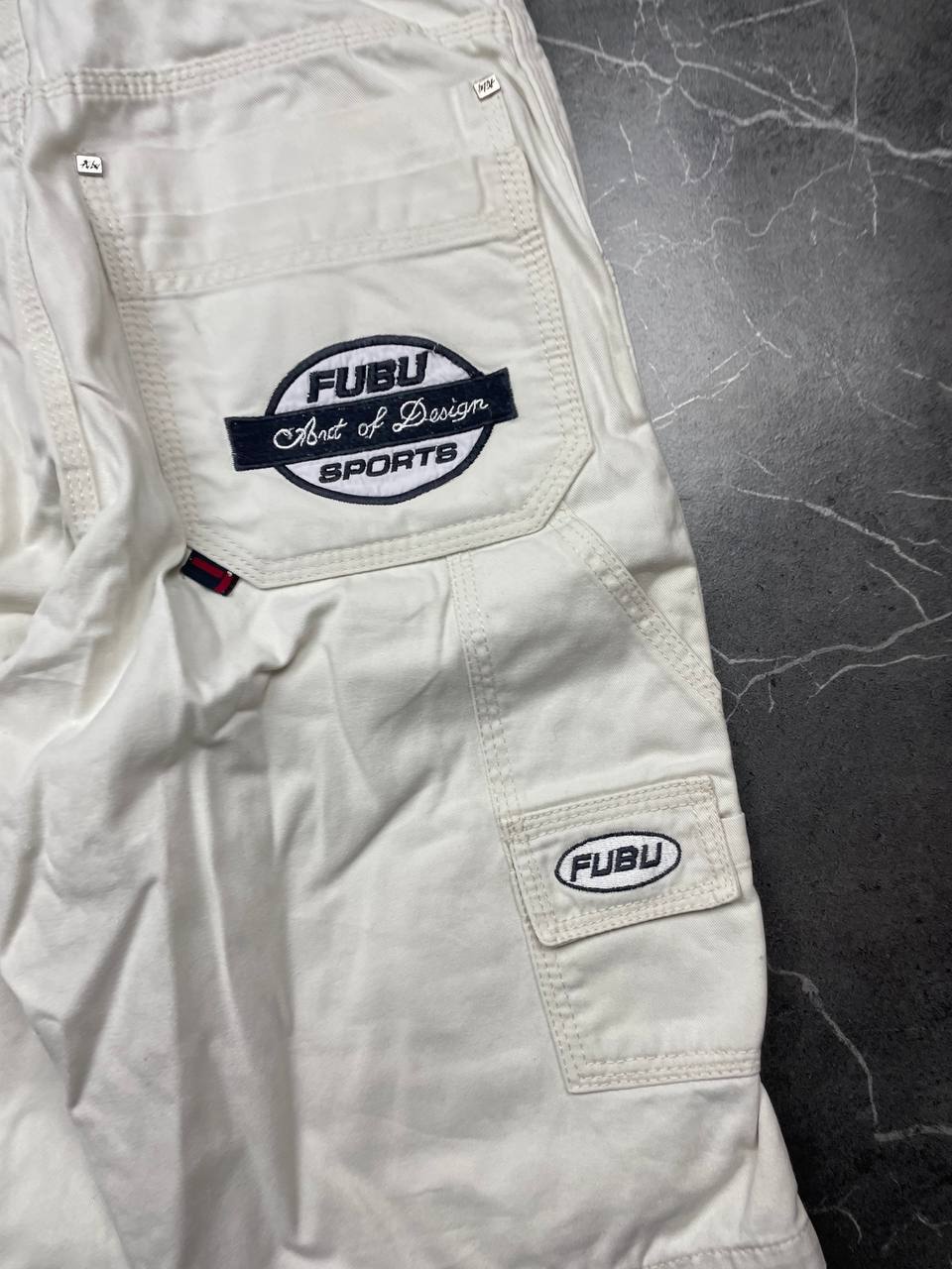 FUBU white cargo shorts 100% cotton with multiple pockets and detailed branding.