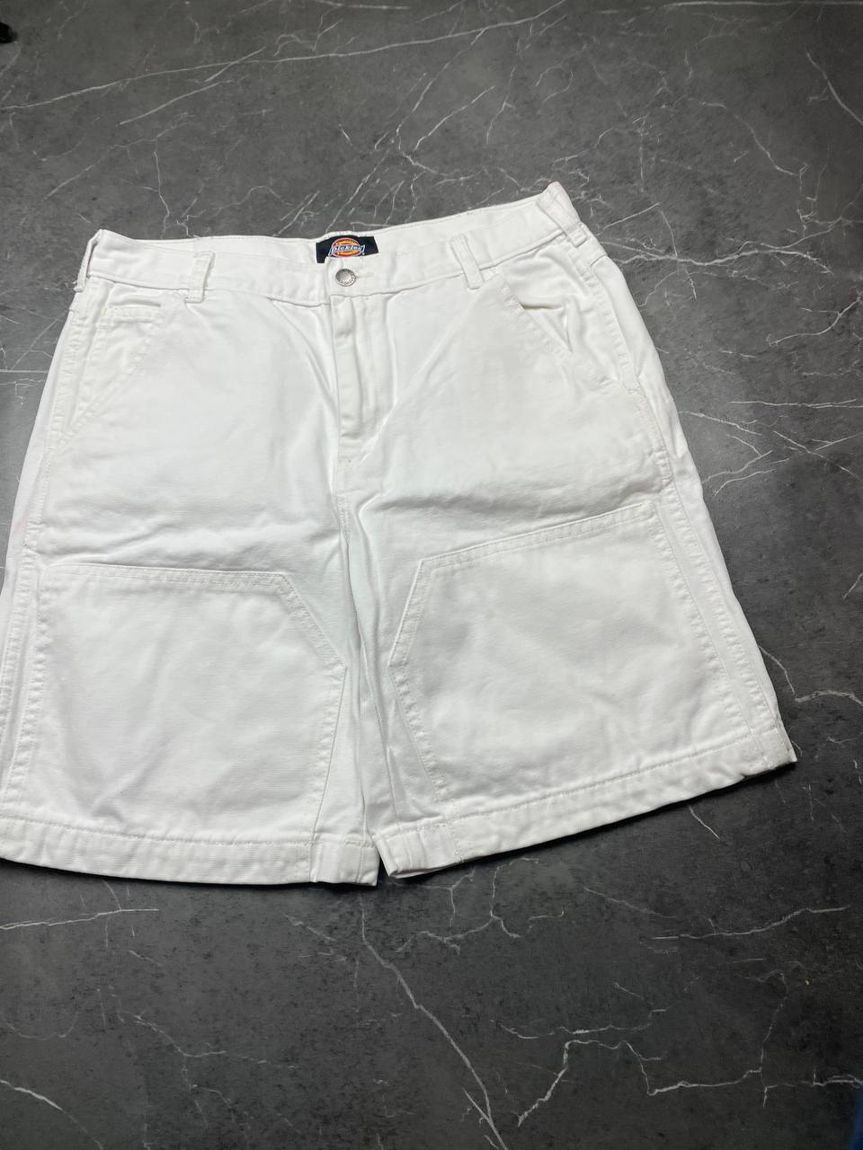 Dickies white cotton work shorts with logo on back pocket and waistband label.