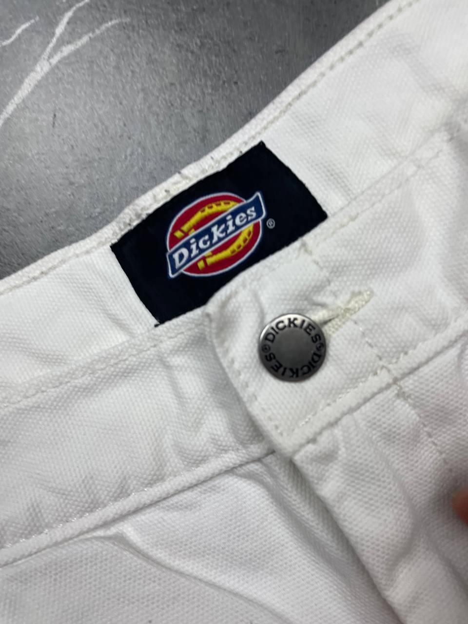 Dickies white cotton work shorts with logo on back pocket and waistband label.
