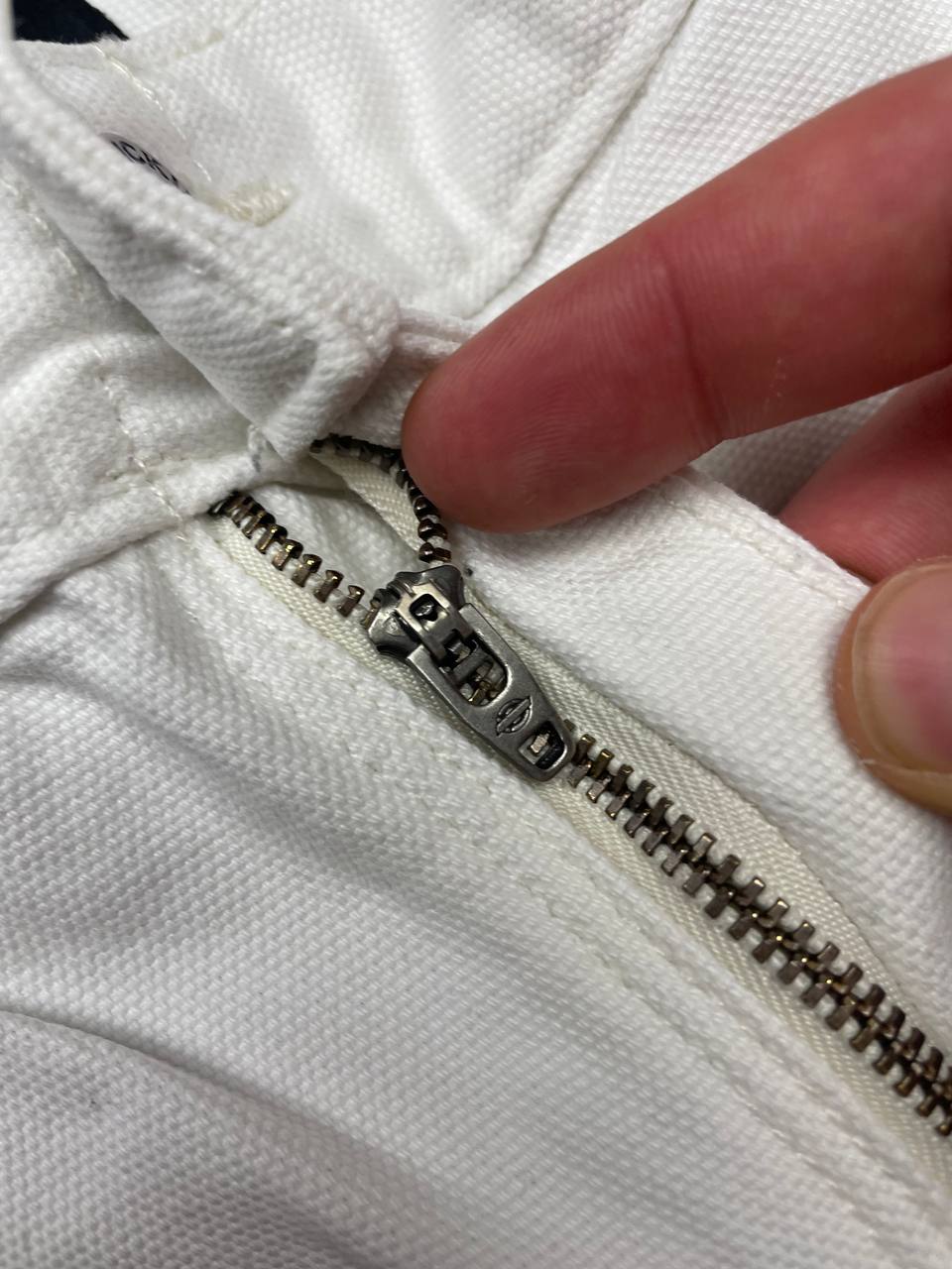 Dickies white cotton work shorts with logo on back pocket and waistband label.