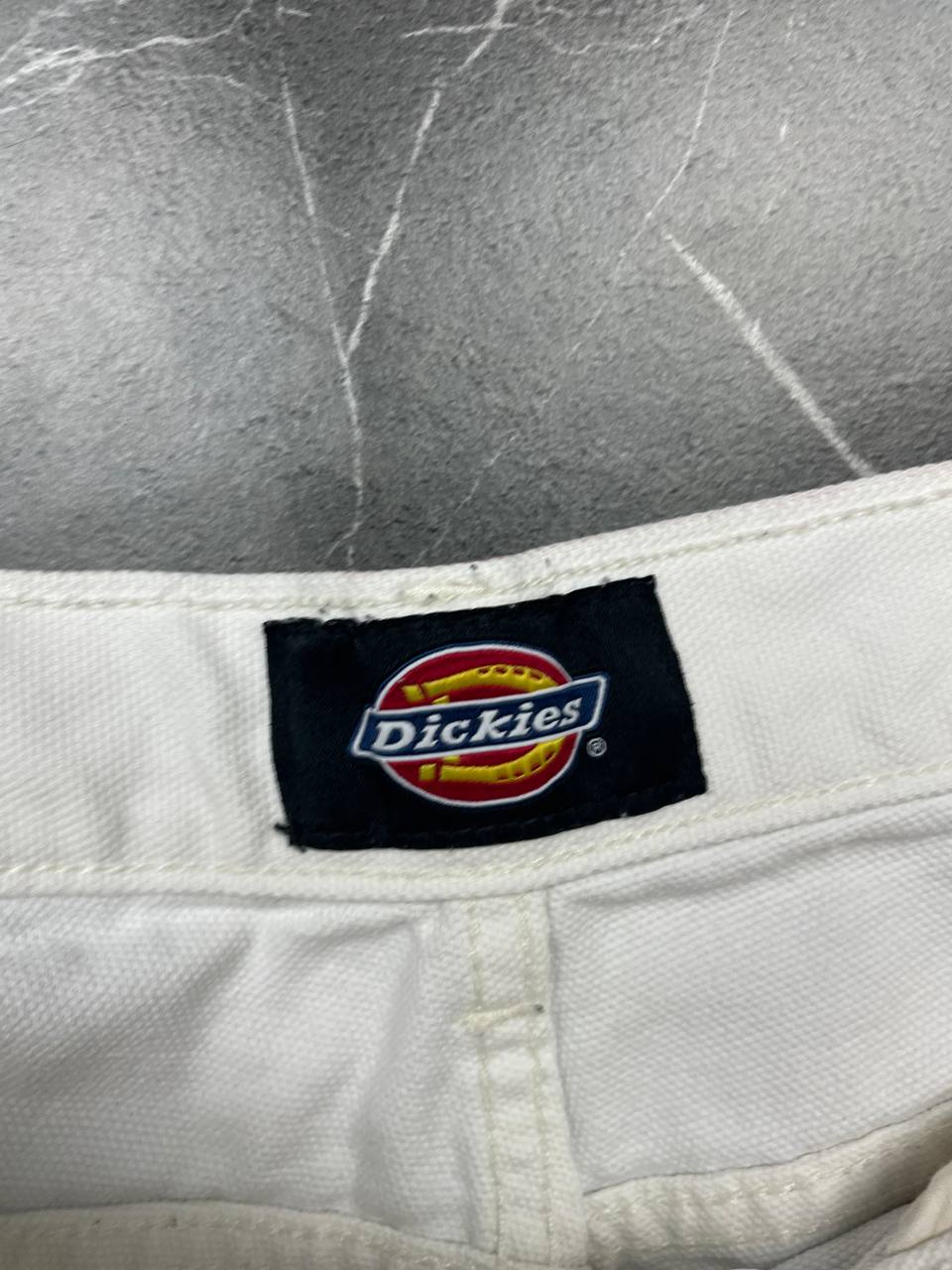 Dickies white cotton work shorts with logo on back pocket and waistband label.