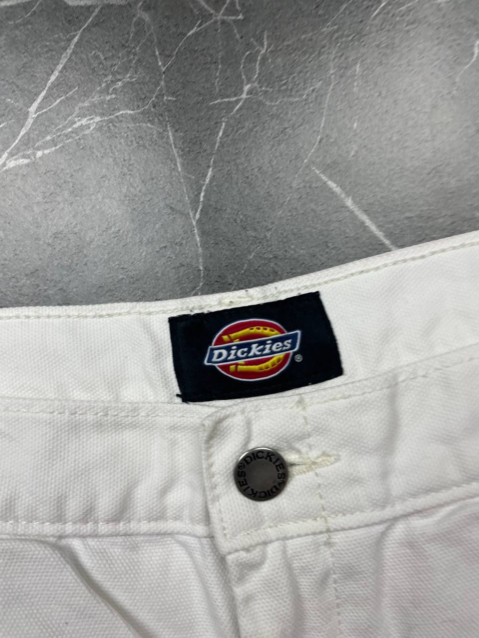 Dickies white cotton work shorts with logo on back pocket and waistband label.