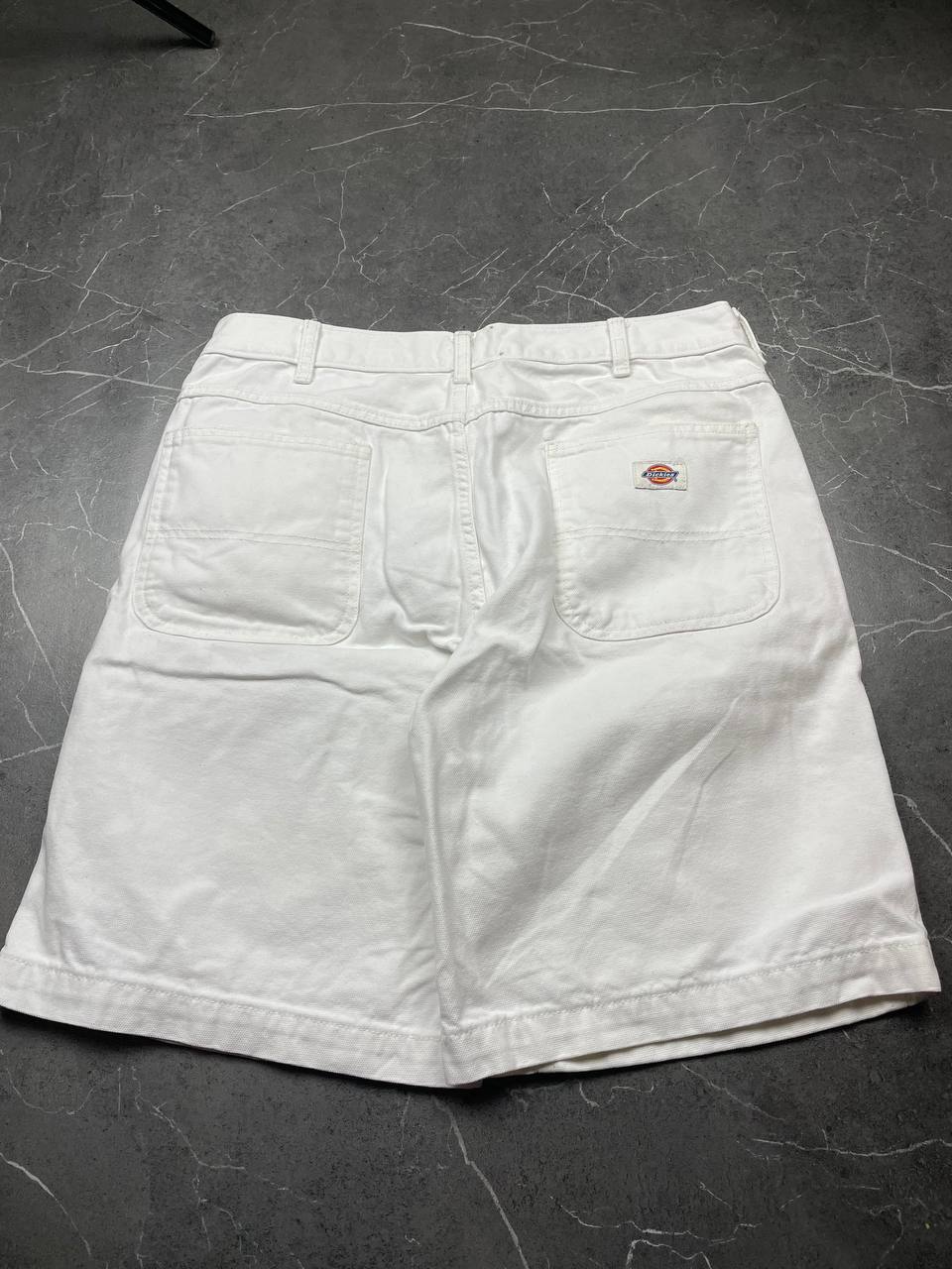 Dickies white cotton work shorts with logo on back pocket and waistband label.