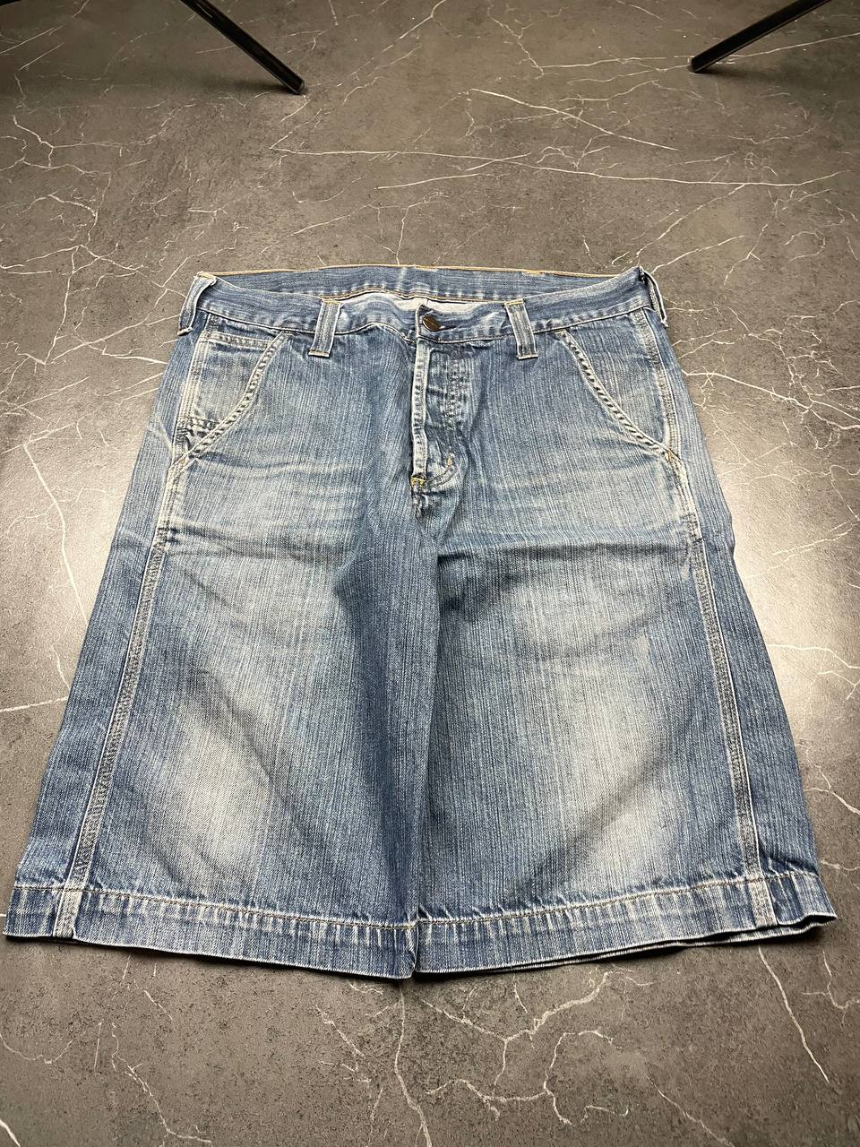 Carhartt blue denim work shorts size 32 with button closure and large back pockets.