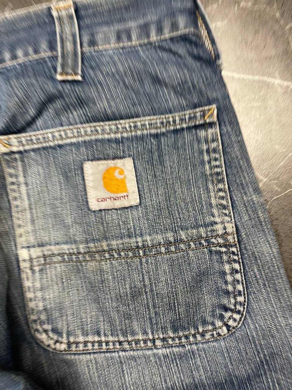 Carhartt blue denim work shorts size 32 with button closure and large back pockets.