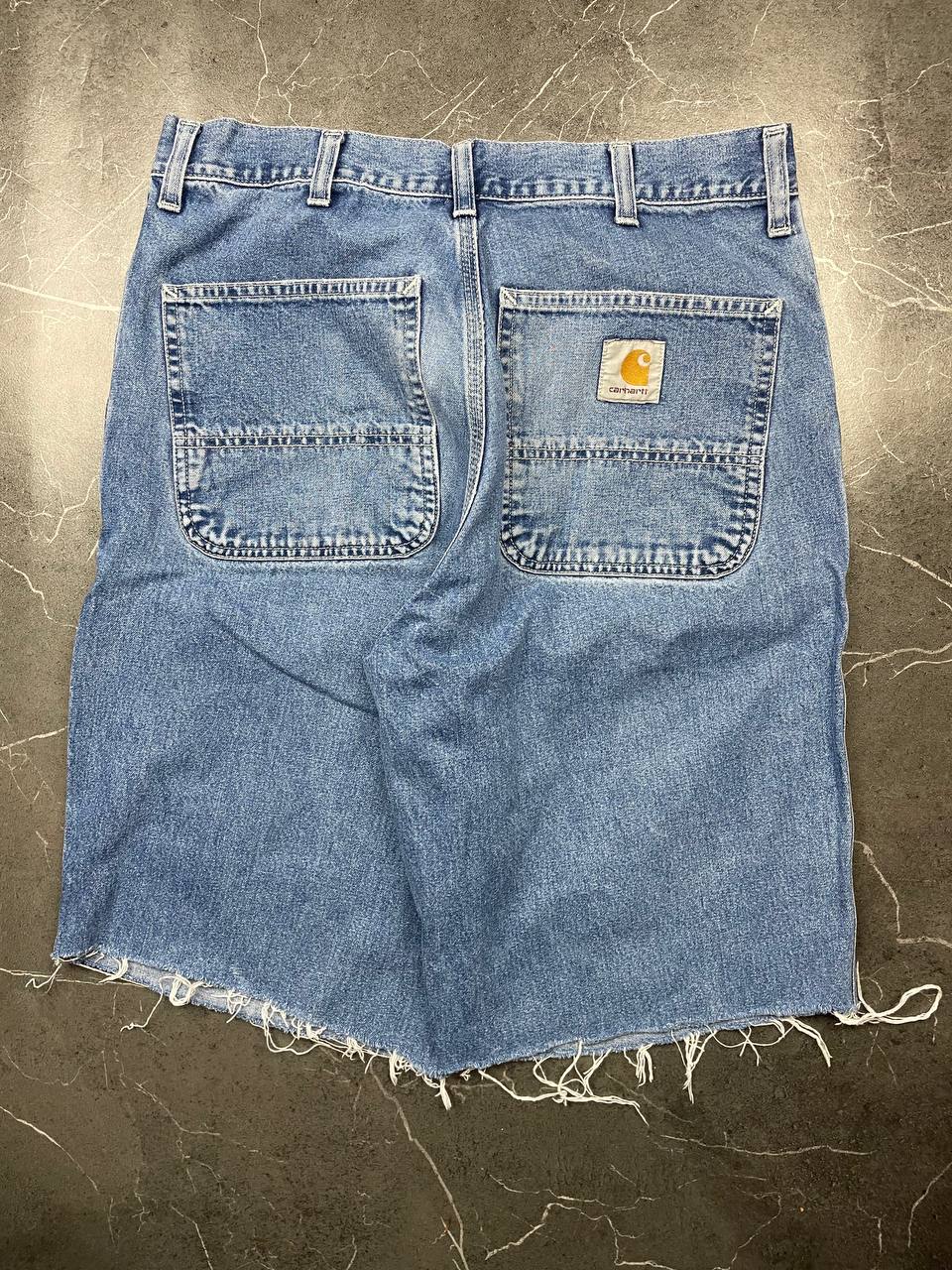 Carhartt blue denim skirt with multiple pockets and hammer loop detail.