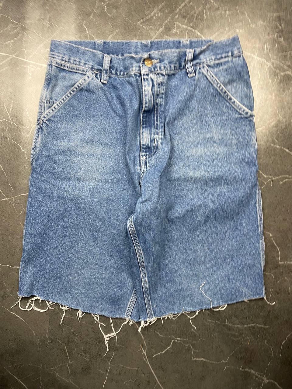 Carhartt blue denim skirt with multiple pockets and hammer loop detail.