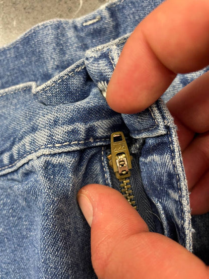 Carhartt blue denim skirt with multiple pockets and hammer loop detail.