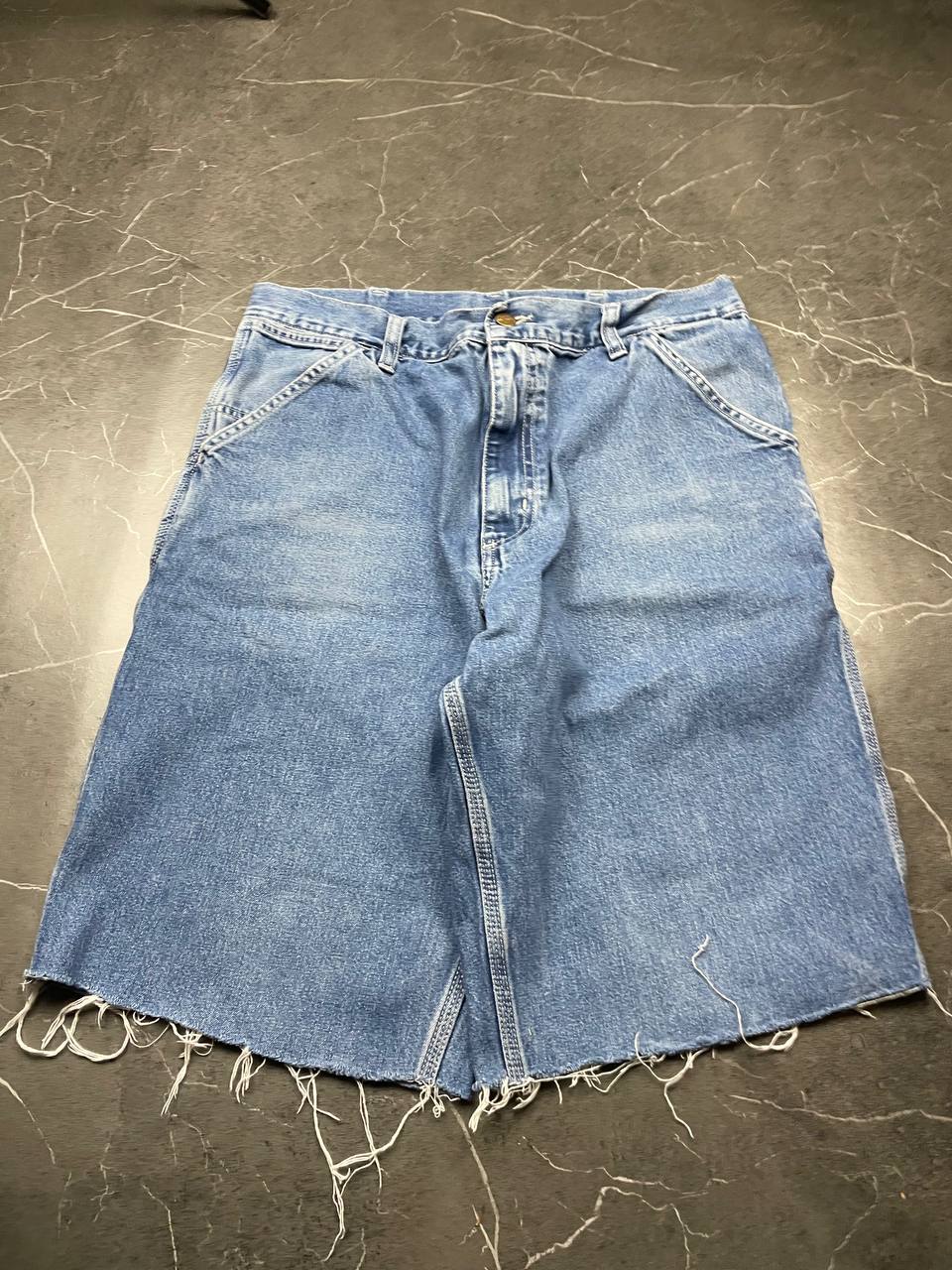 Carhartt blue denim skirt with multiple pockets and hammer loop detail.