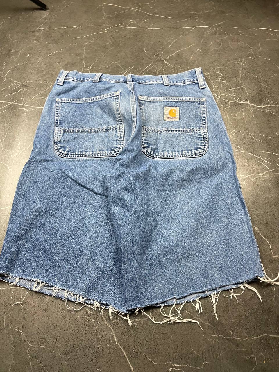 Carhartt blue denim skirt with multiple pockets and hammer loop detail.