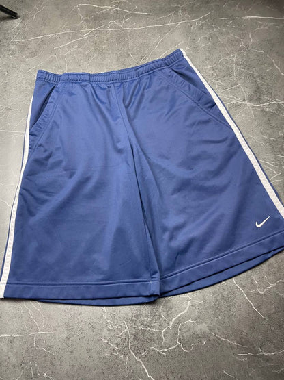 Nike blue sports shorts with white side stripes and small swoosh logo, zip pocket.