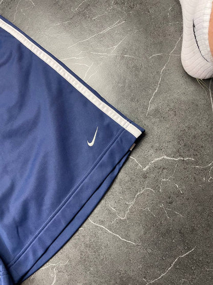 Nike blue sports shorts with white side stripes and small swoosh logo, zip pocket.