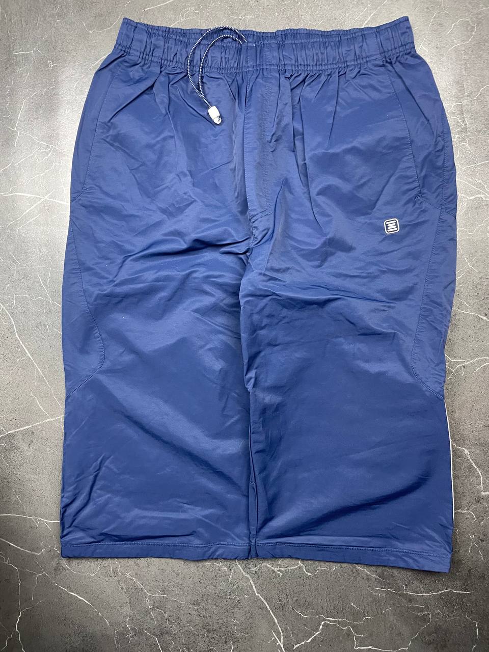 Nike blue woven shorts with elastic waistband, logo on front, and mesh lining.