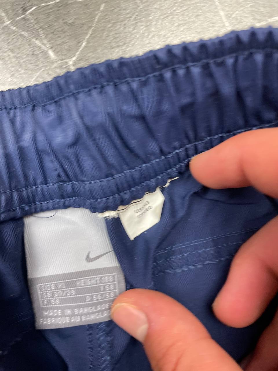 Nike blue woven shorts with elastic waistband, logo on front, and mesh lining.