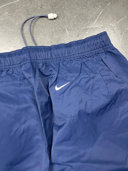 Nike blue woven shorts with elastic waistband, logo on front, and mesh lining.