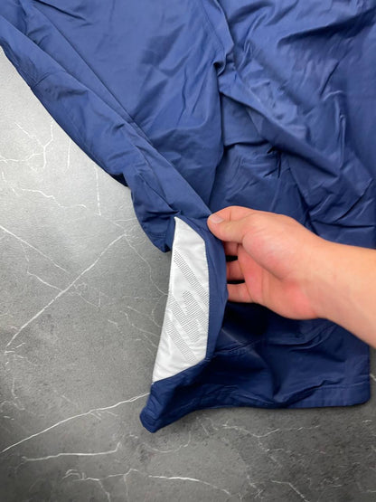 Nike blue woven shorts with elastic waistband, logo on front, and mesh lining.