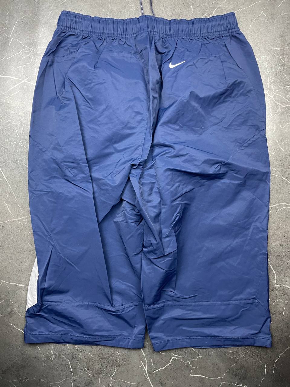 Nike blue woven shorts with elastic waistband, logo on front, and mesh lining.