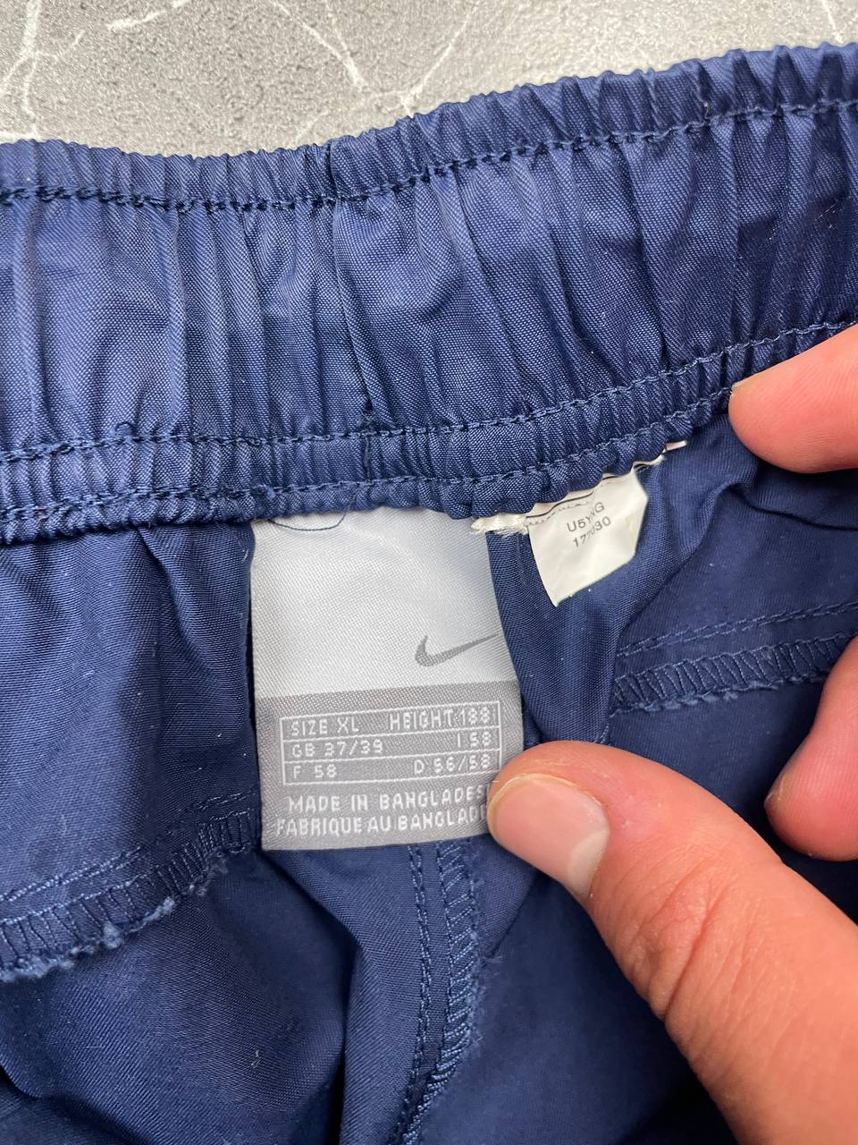 Nike blue woven shorts with elastic waistband, logo on front, and mesh lining.