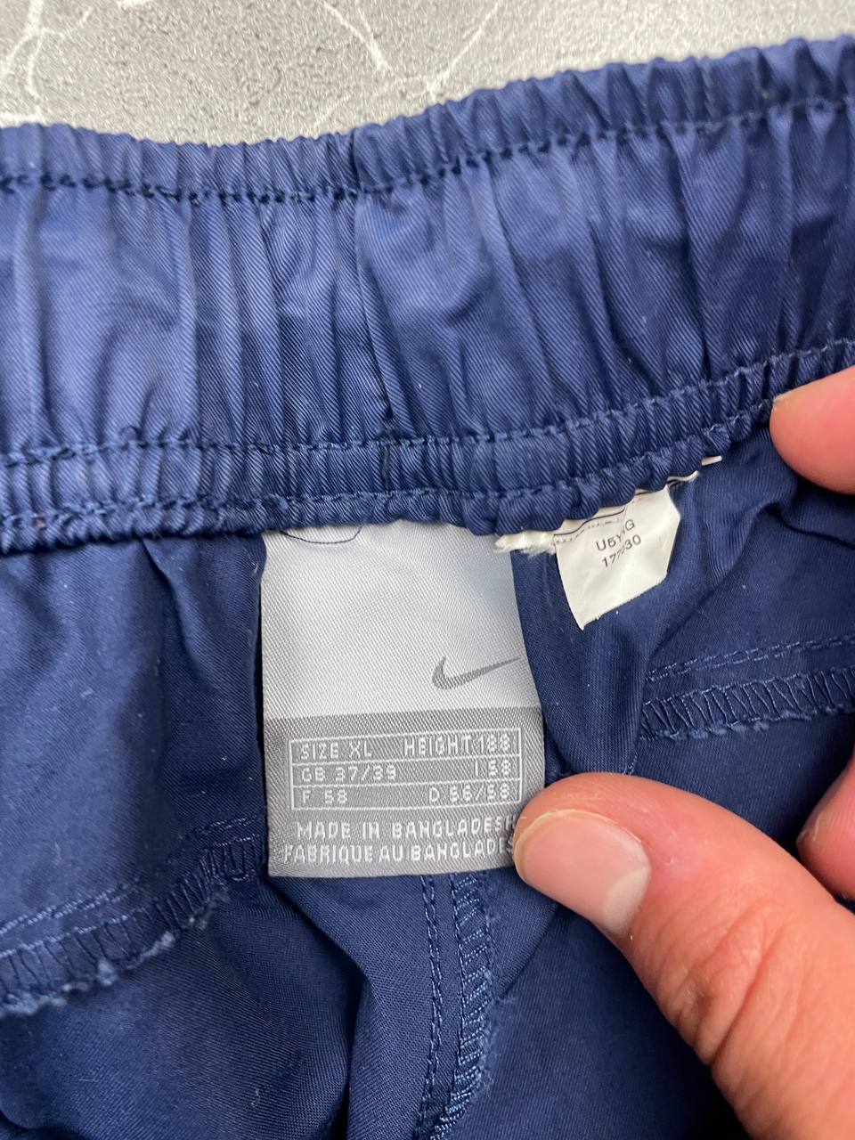 Nike blue woven shorts with elastic waistband, logo on front, and mesh lining.