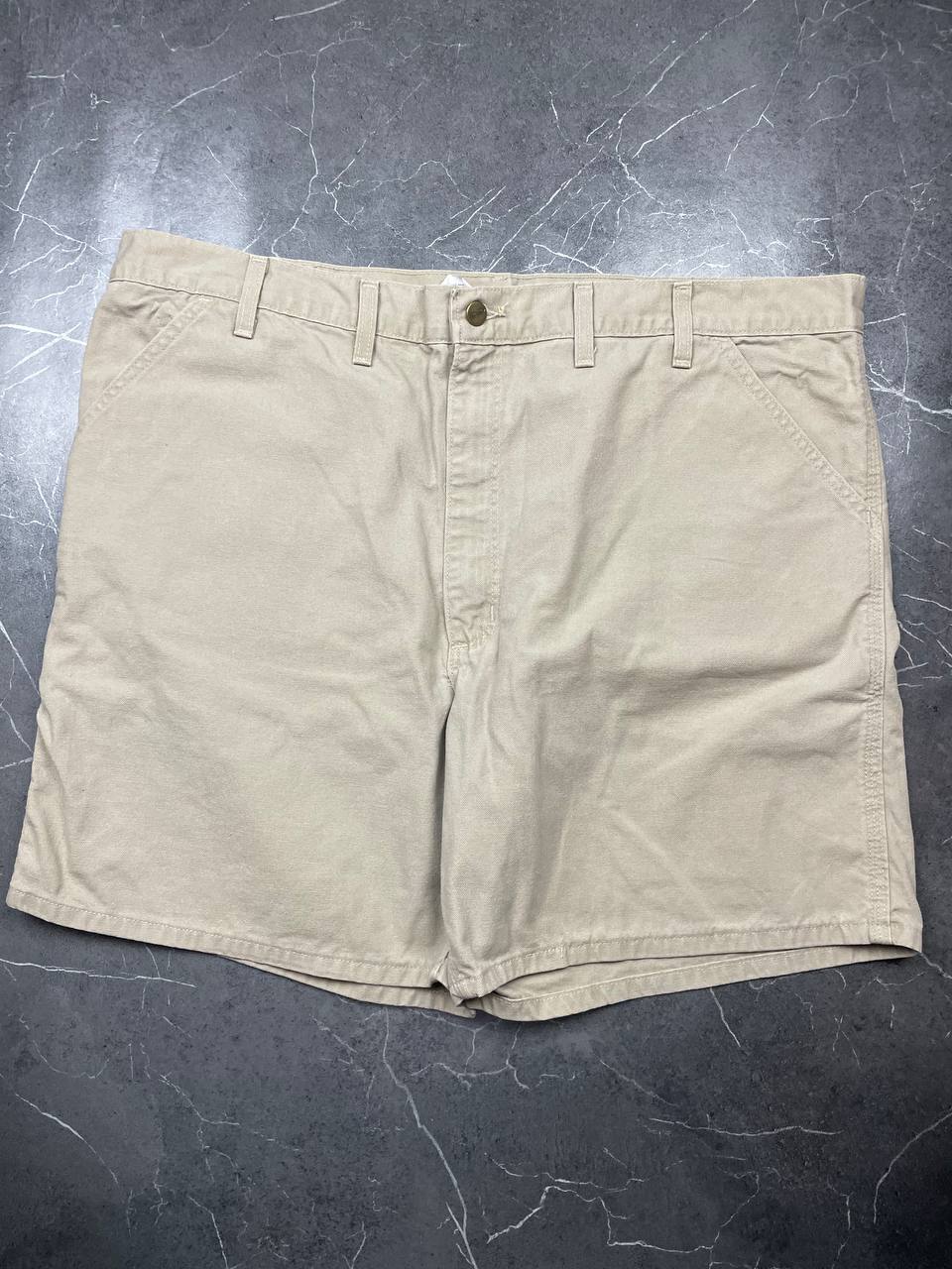 Carhartt beige cotton work shorts relaxed fit with logo patch and multiple pockets.