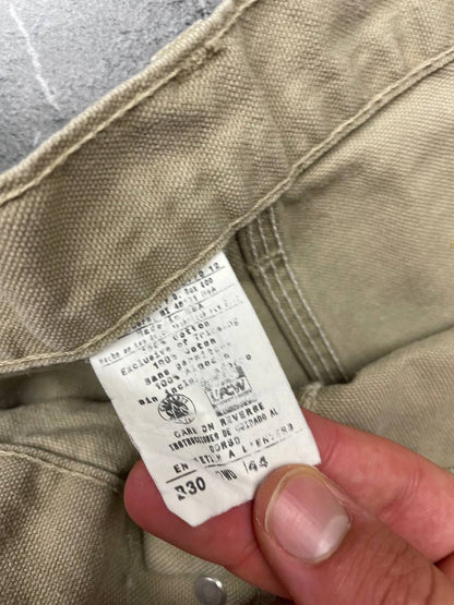 Carhartt beige cotton work shorts relaxed fit with logo patch and multiple pockets.