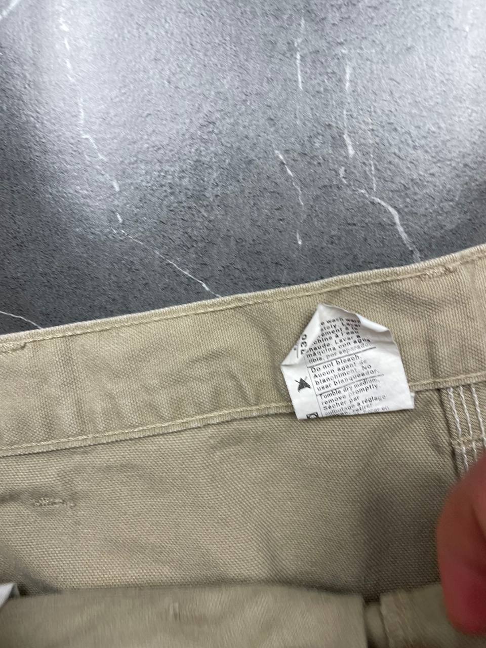 Carhartt beige cotton work shorts relaxed fit with logo patch and multiple pockets.