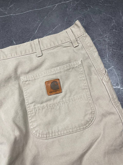 Carhartt beige cotton work shorts relaxed fit with logo patch and multiple pockets.