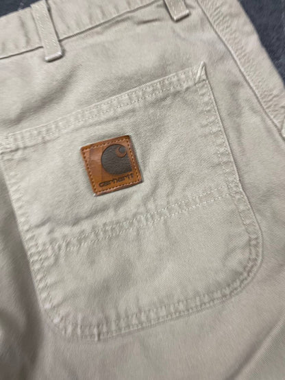 Carhartt beige cotton work shorts relaxed fit with logo patch and multiple pockets.