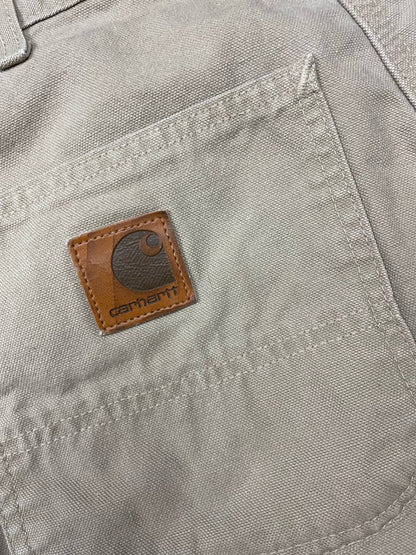 Carhartt beige cotton work shorts relaxed fit with logo patch and multiple pockets.