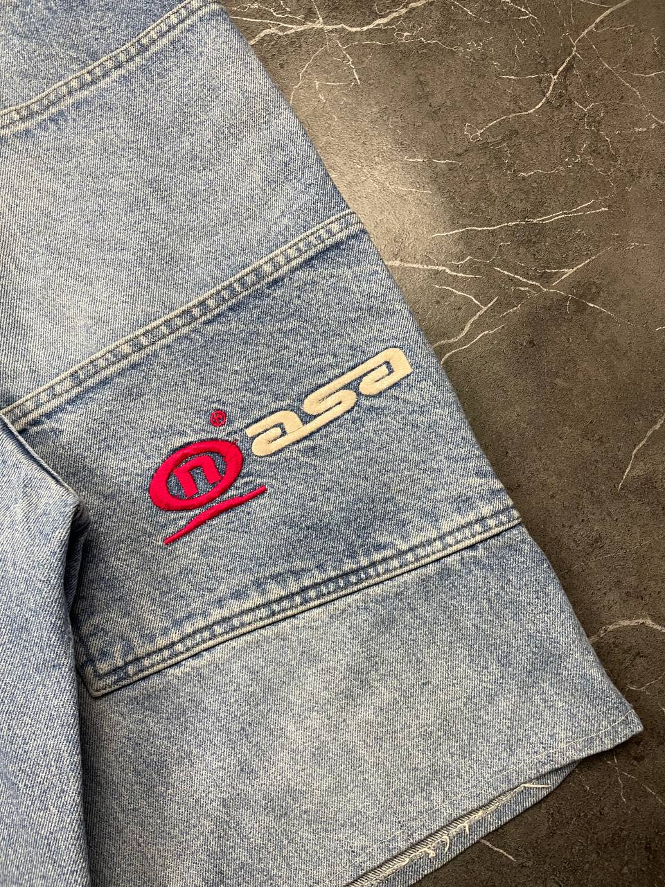 NASA Clothing light blue denim shorts with embroidered logo and classic 5-pocket styling.