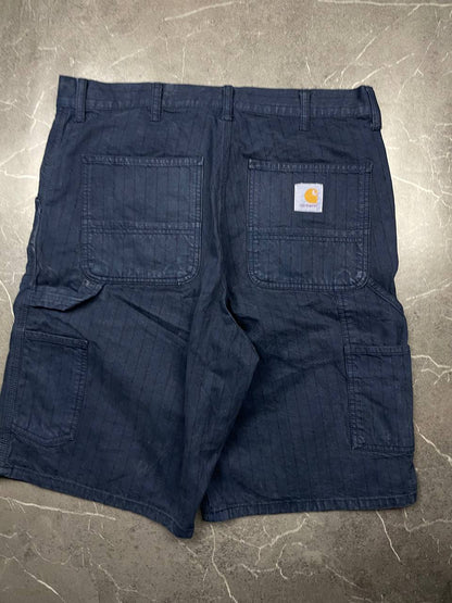 Carhartt navy shorts with pinstripe detail and logo patch on back pocket.