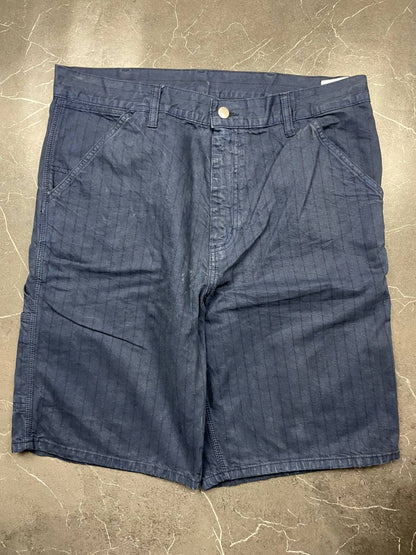 Carhartt navy shorts with pinstripe detail and logo patch on back pocket.