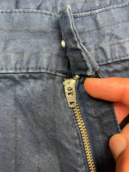 Carhartt navy shorts with pinstripe detail and logo patch on back pocket.