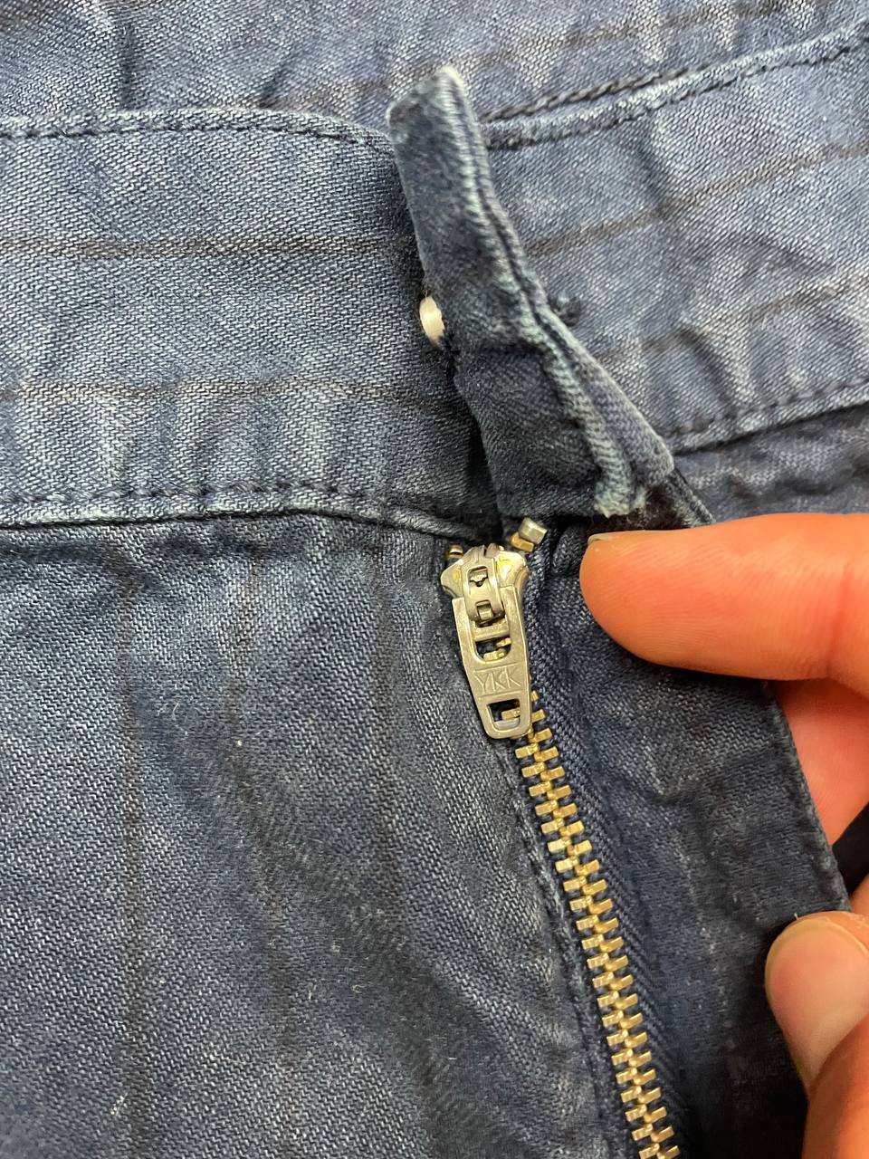 Carhartt navy shorts with pinstripe detail and logo patch on back pocket.