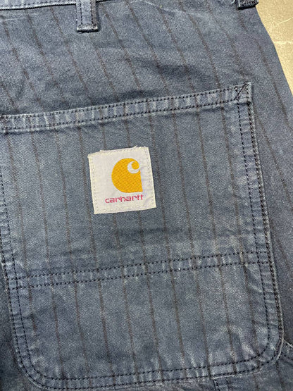 Carhartt navy shorts with pinstripe detail and logo patch on back pocket.
