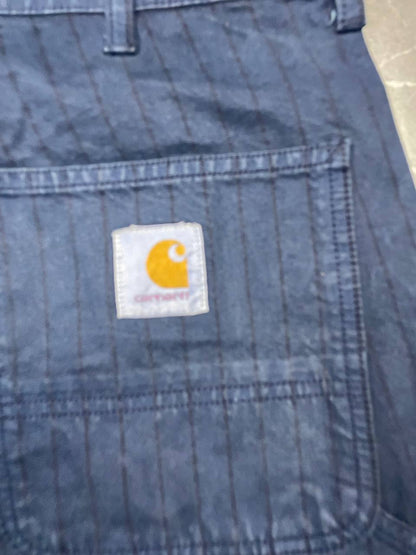 Carhartt navy shorts with pinstripe detail and logo patch on back pocket.